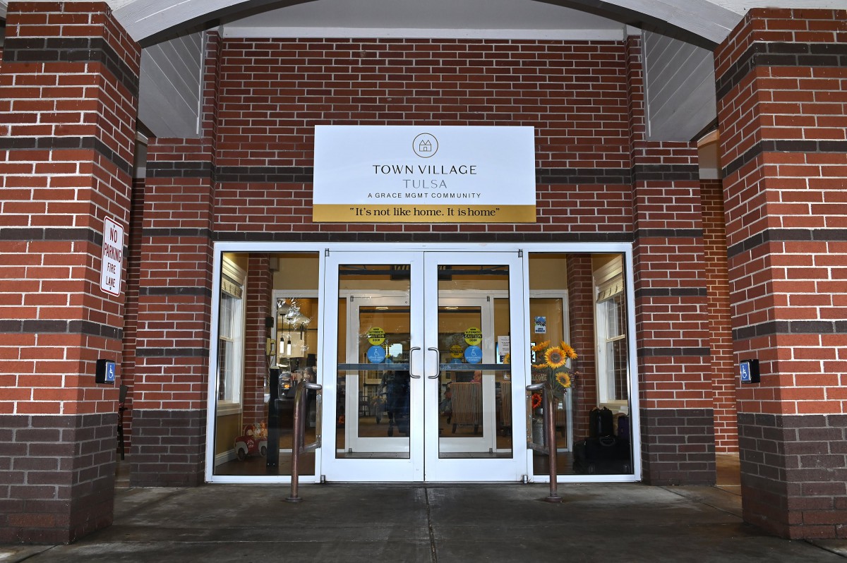 Entrance to a restaurant with glass doors and brick exterior.