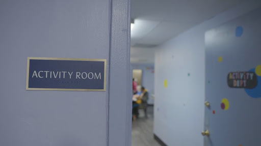 A sign indicating the 'Hospitality Room' in a hallway.