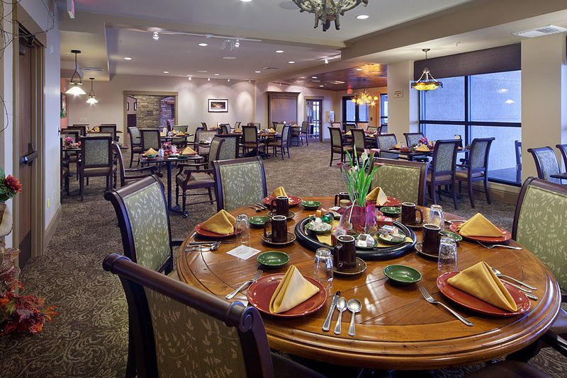 A beautifully set dining room with elegant tables and chairs prepared for guests.