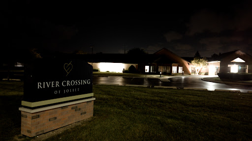 A nighttime view of a community center with illuminated signage.