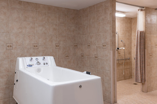 A modern bathroom featuring a sleek bathtub and tiled walls.