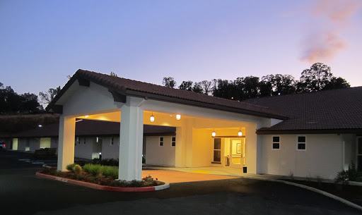 A welcoming entrance of a hotel or inn illuminated at dusk.