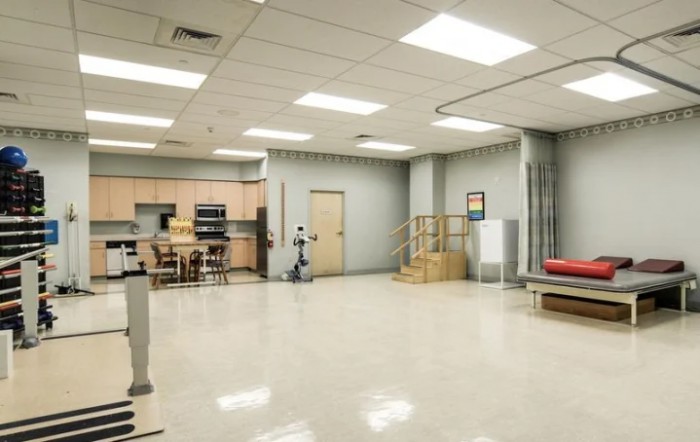 A spacious rehabilitation clinic equipped with exercise and therapy equipment.