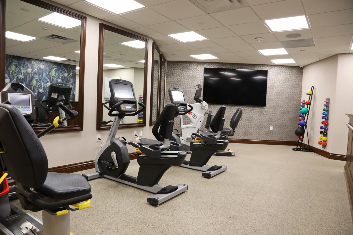 A modern gym with exercise bikes and fitness equipment.
