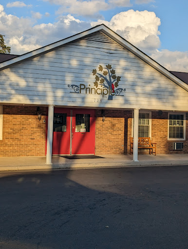 A welcoming entrance to a community-oriented building with a vibrant logo.