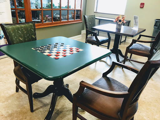 A cozy lounge area featuring game tables with checkerboard designs.