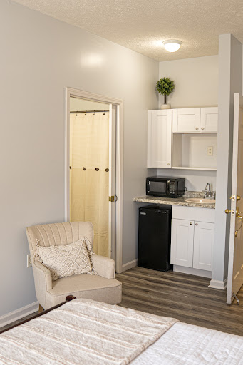 A cozy living space featuring a small kitchenette and comfortable seating.
