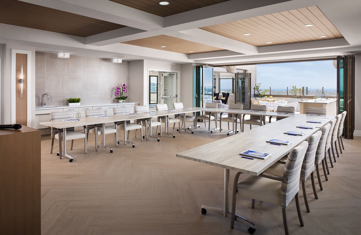 A modern conference room with arranged seating, ample natural light, and sleek design.