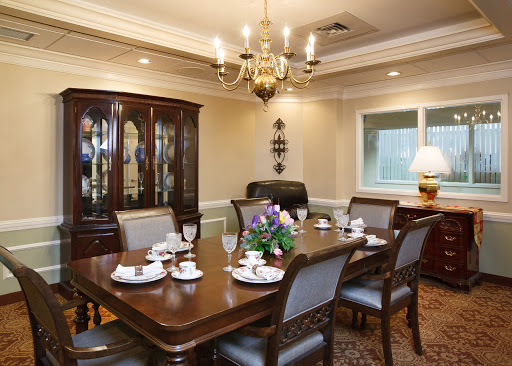 An elegant dining room ready for a formal gathering, featuring a beautifully set table and classic decor.
