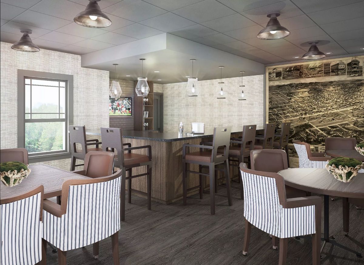 A modern restaurant interior with seating and a bar area.