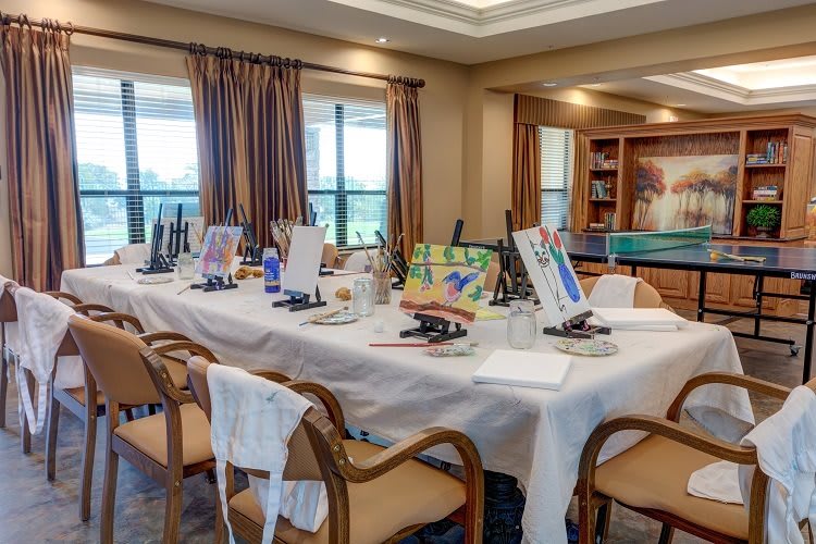 An art studio with canvases and easels set up for a painting class.