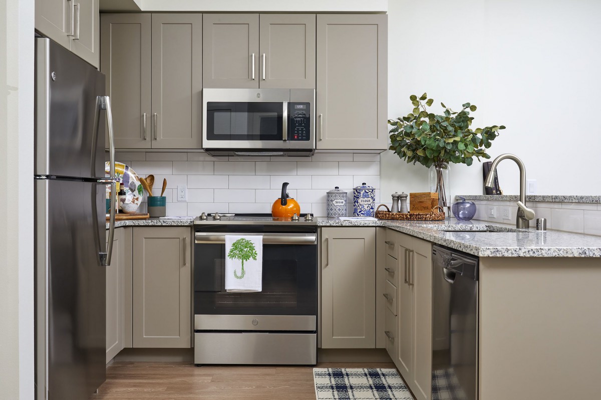 A modern kitchen with stainless steel appliances and elegant decor.