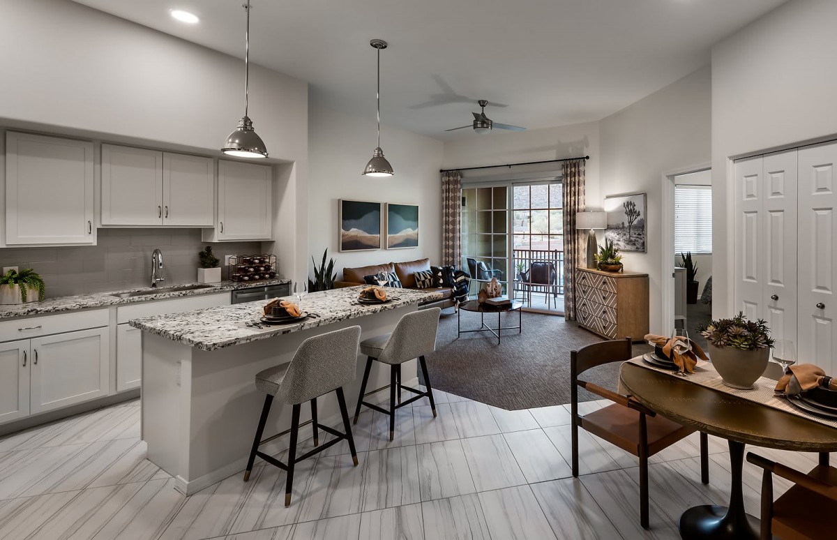 A modern open-concept kitchen and living room with stylish interior design elements.