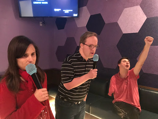 A fun karaoke night with friends, singing their hearts out.