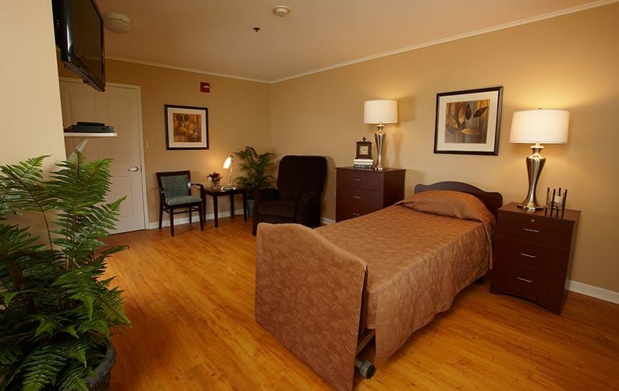A cozy bedroom with a single bed, wooden flooring, and elegant furnishings.