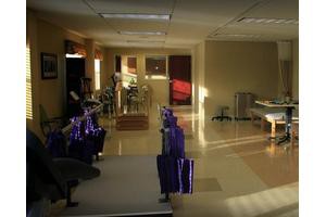 A gym interior with exercise equipment such as treadmills and machines.