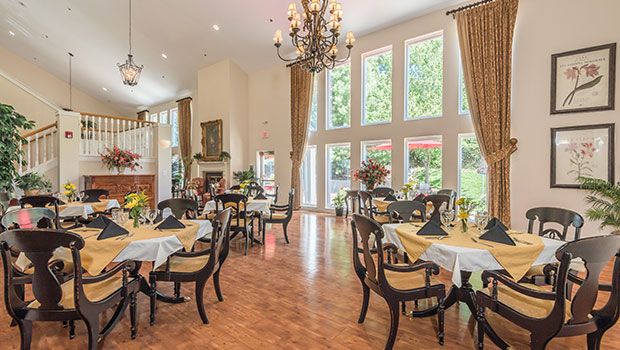 An elegant dining room with large windows and exquisite decor.