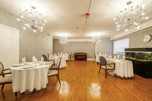 A beautifully designed dining area featuring elegant tables and chandeliers.