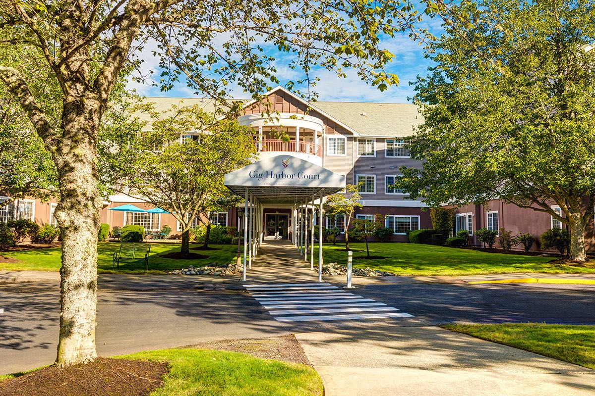 A well-maintained building entrance surrounded by greenery.
