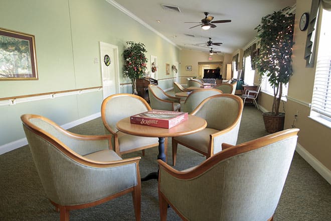 A cozy lounge with comfortable chairs and a table in a spacious room.