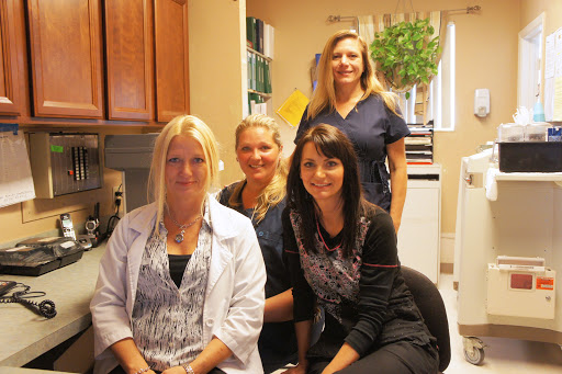 A team of healthcare professionals posing together in an office setting.