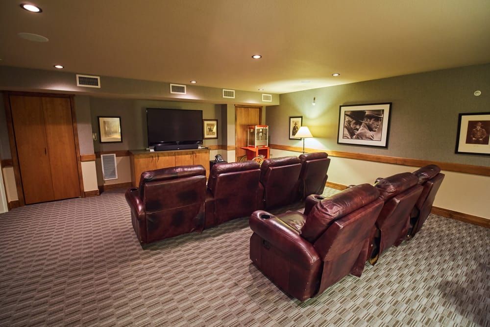 A cozy home theater setup with recliner chairs and a large screen TV.