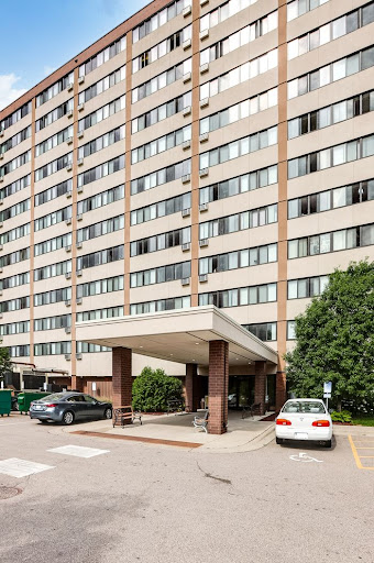 A multi-story residential building with a covered entrance.
