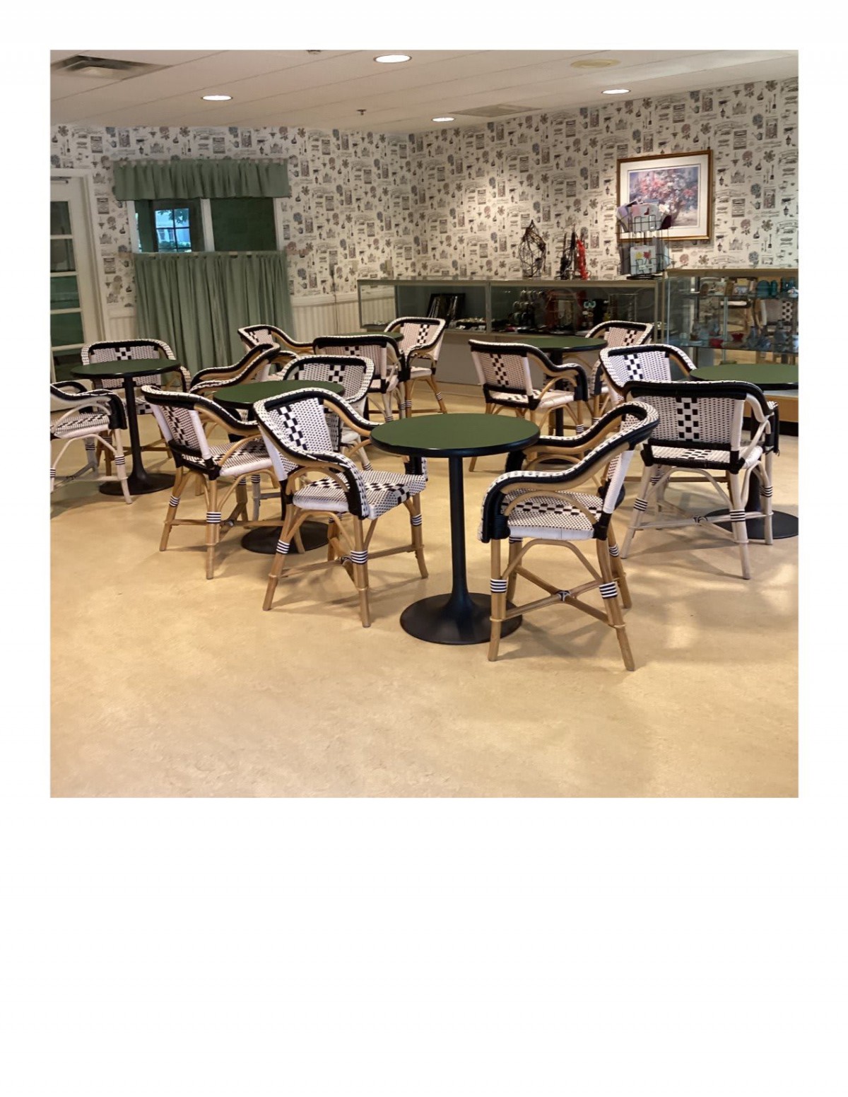 An empty restaurant seating area with bistro-style tables and chairs.