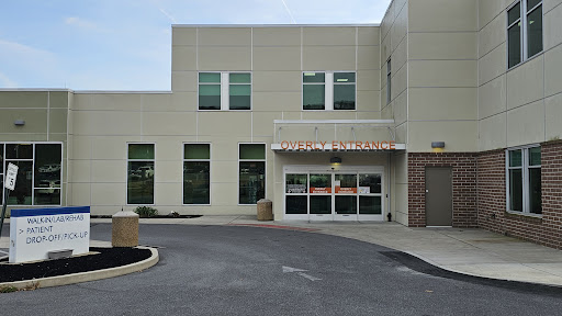 A modern commercial building with large windows and an accessible entrance.
