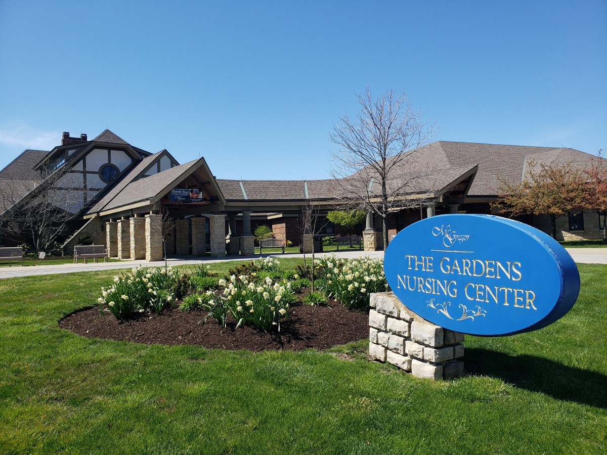 The Gardens Nursing Center with a welcoming sign and well-maintained landscaping.