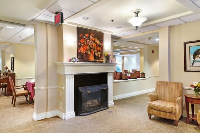 A cozy lobby interior featuring a fireplace and comfortable seating.