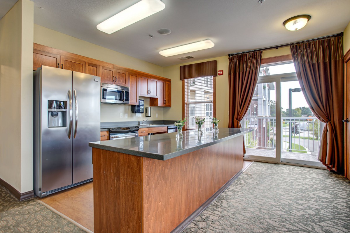 A modern kitchen with stainless steel appliances and a spacious island.