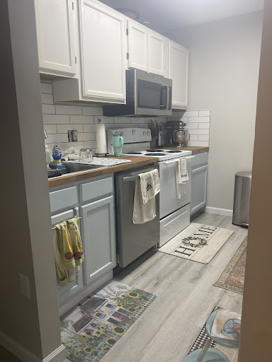 A modern kitchen with stainless steel appliances and a cozy atmosphere.