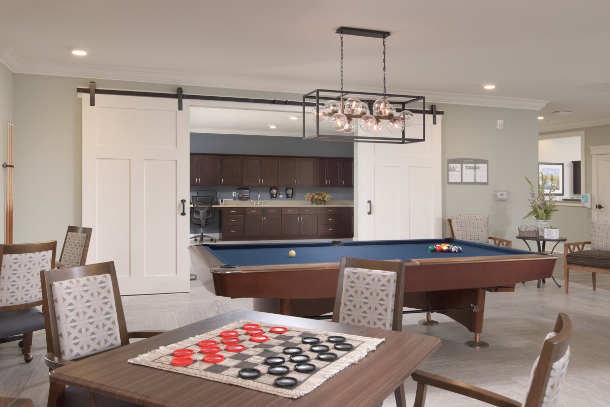 A stylish game room featuring a pool table and a checkers board.