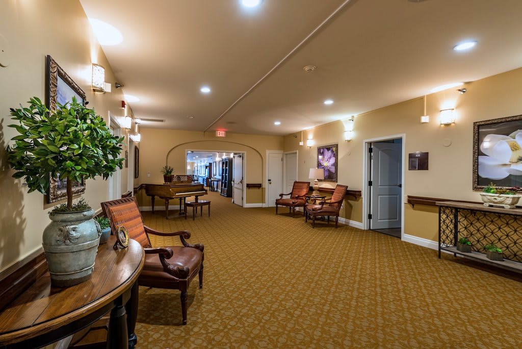 A well-lit hallway with comfortable seating and tasteful decor.