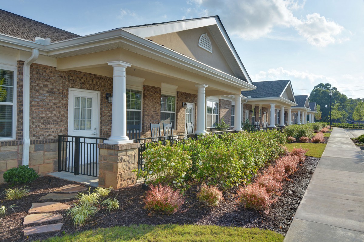 A row of modern houses with landscaped gardens and inviting porches.