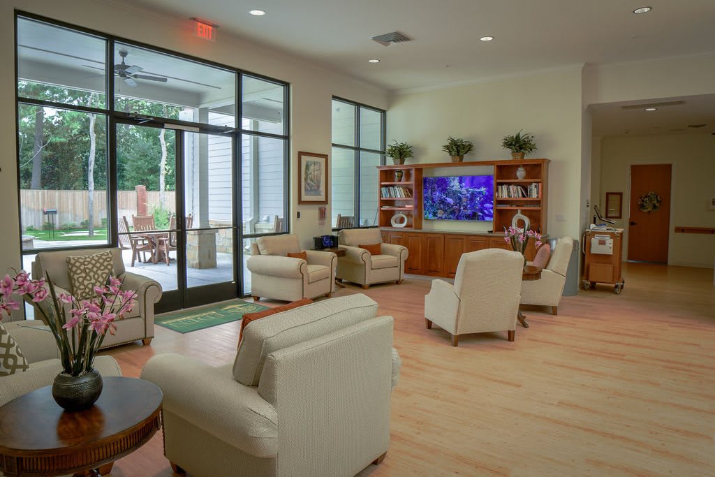 A modern living room with comfortable seating and a large TV.