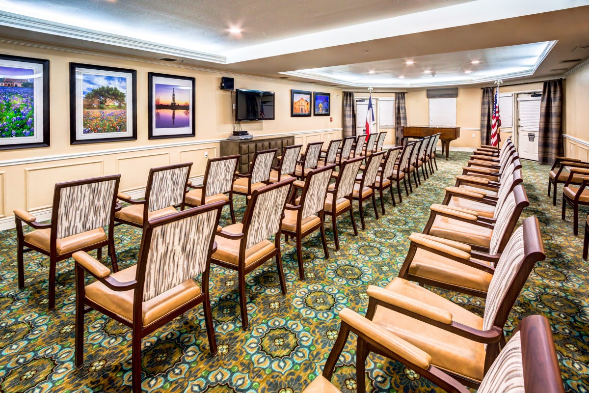 A neatly arranged conference room with rows of chairs facing a presentation area.