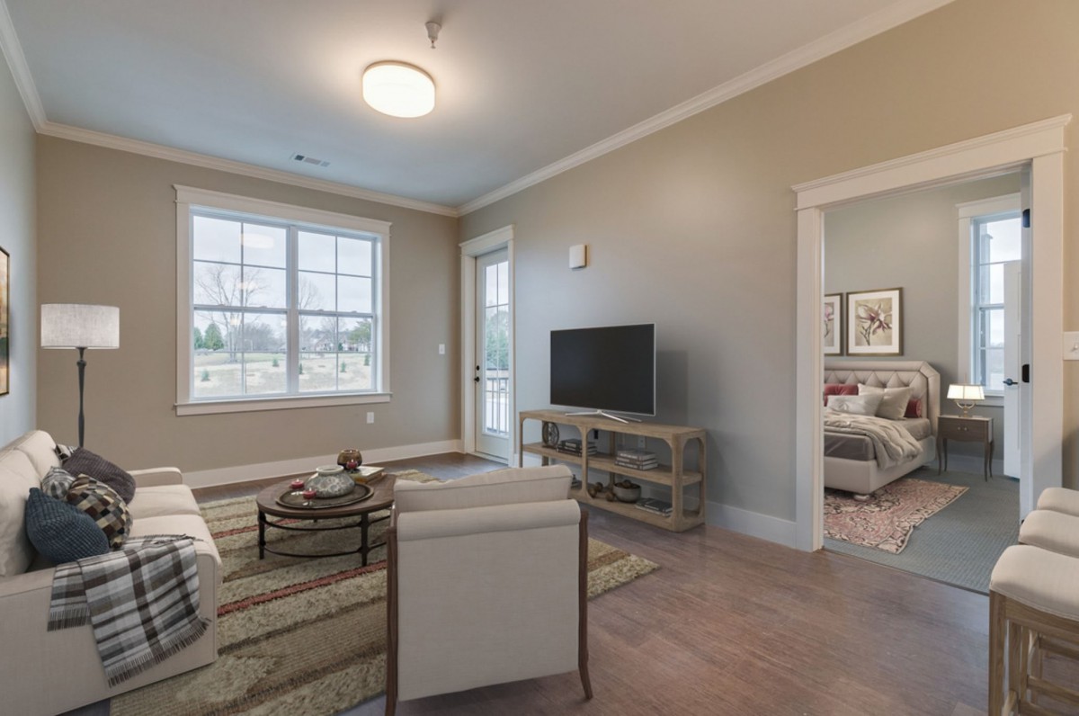 A cozy living room with modern furniture and ample natural light.