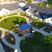 Aerial view of a building with landscaped gardens and pathways.