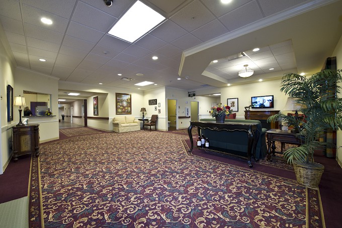 A spacious and well-lit lobby area with comfortable seating and decorative carpeting.