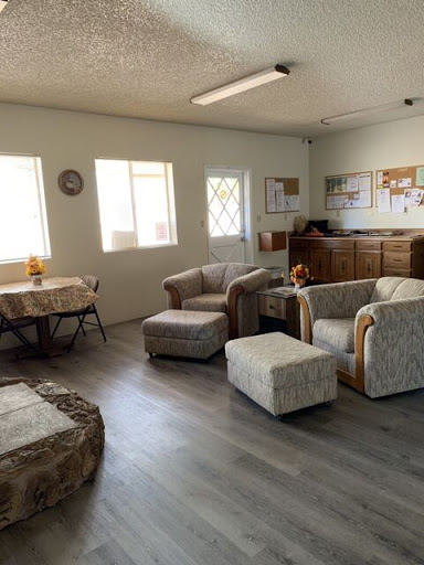 A cozy living room space featuring comfortable seating and ample natural light.