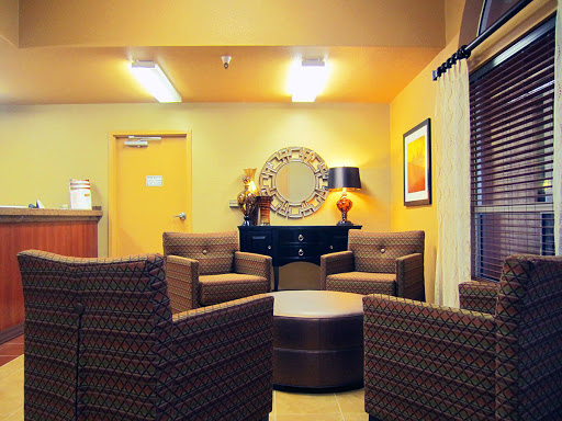 A cozy lounge area featuring comfortable seating, warm lighting, and modern decor.