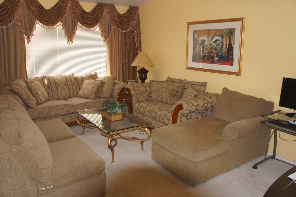 A cozy living room with a sectional sofa, coffee table, and elegant decor.
