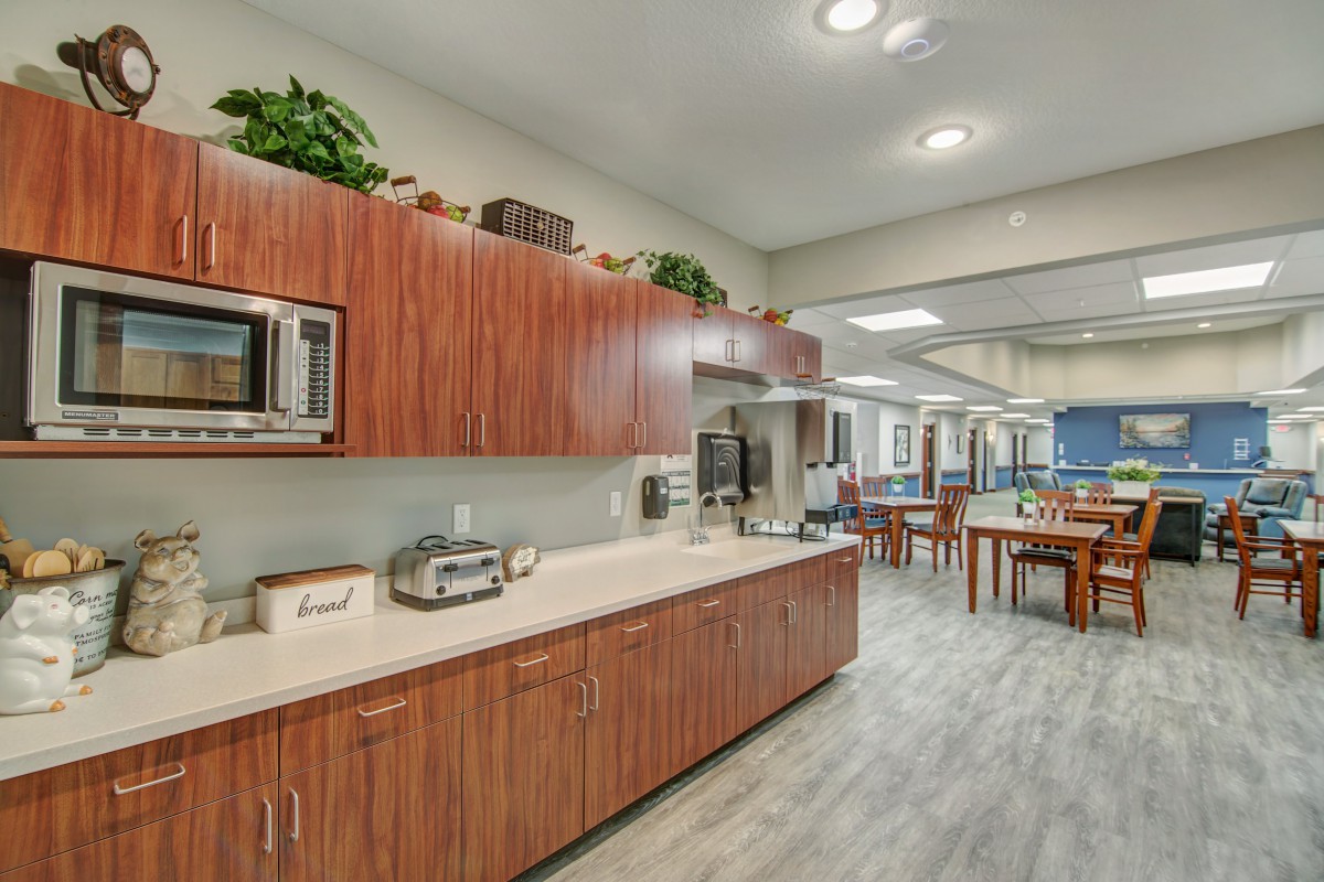 A modern kitchen with wooden cabinets and appliances on the countertop.