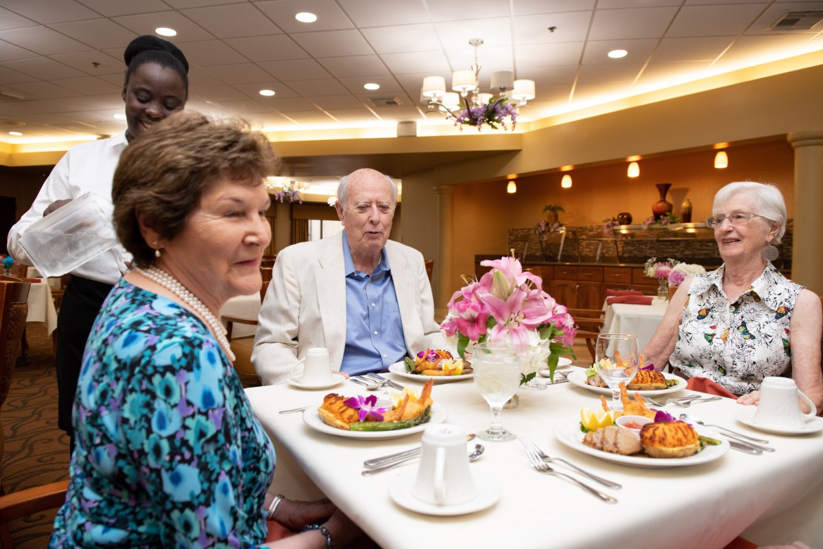 A group of people enjoying a meal together at a restaurant.