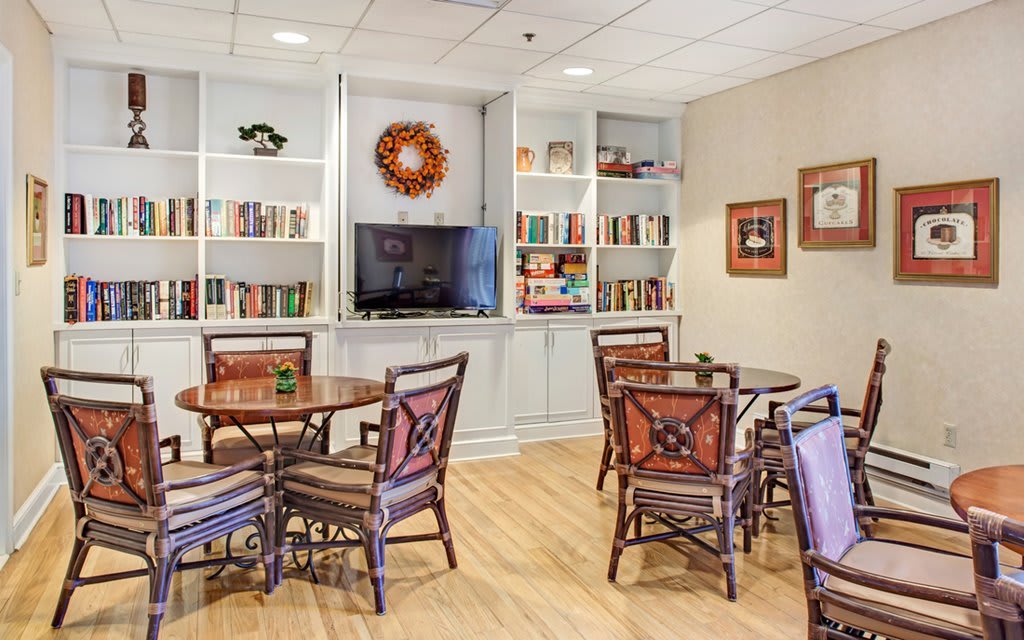 A cozy library with seating and bookshelves.