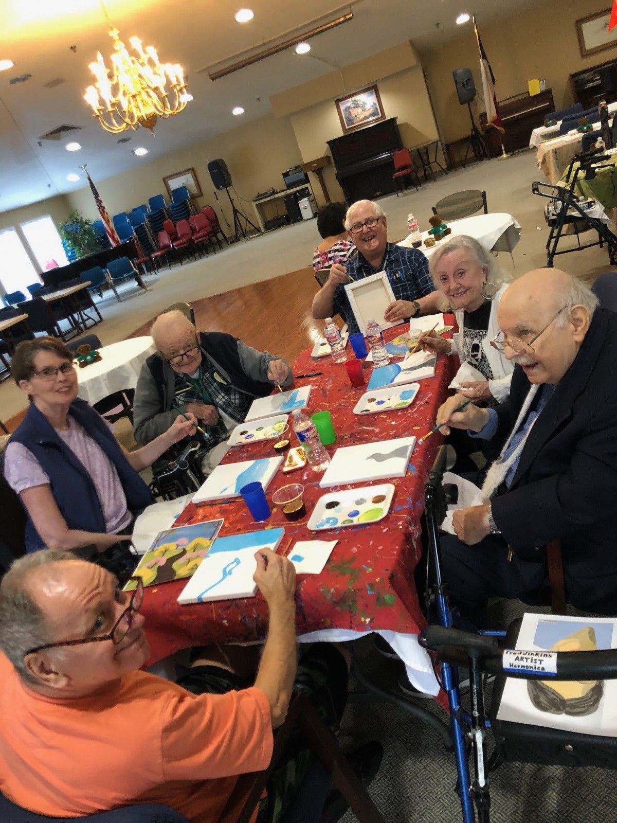 A group of seniors enjoying an activity together at a table in a community setting.