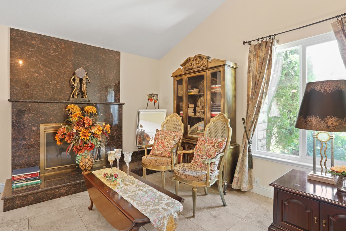 A traditional living room with antique furniture and vintage decor.