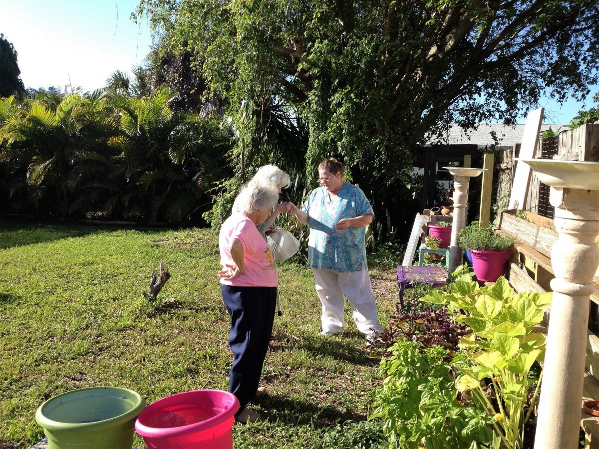 Two people enjoying a sunny day in the garden.